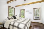 Primary bedroom with a king size bed and window AC unit